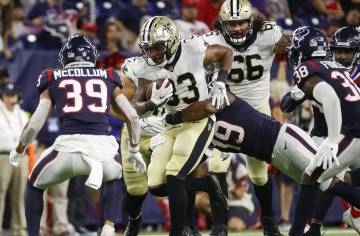 New Orleans Saints running back Abram Smith (33) runs as Houston Texans linebacker Tae Davis (19) attempts to make a tackle. Mandatory Credit: Troy Taormina-USA TODAY
